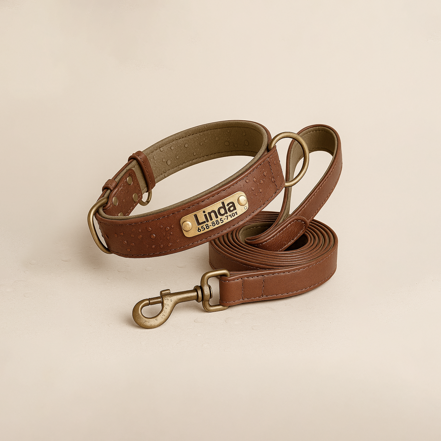 Brown leather dog collar and leash set with 'Linda' branding on a beige background